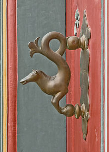 Door knocker with the name Brunswick Horse at the front door of a half-timbered house dating from the year 1719 in the town centre of Goslar.