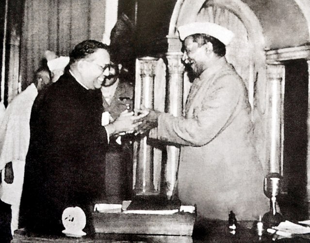 Babasaheb Ambedkar, chairman of the drafting committee, presenting the final draft of the Indian constitution to Constituent Assembly president Rajend