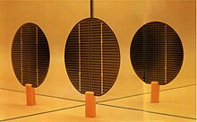 Early bifacial solar cells at IES-UPM (late 1970s). A single BSC with its rear side reflected in mirrored walls. Early bifacial solar cells at IES-UPM (1978).jpg