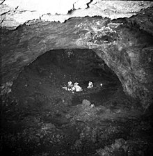 Falemauga Caves showing a large chamber with a group of people inside (1957 photo). F 2 067 155 AK Uni Falemauga Caves 1957 unknown photographer.jpg