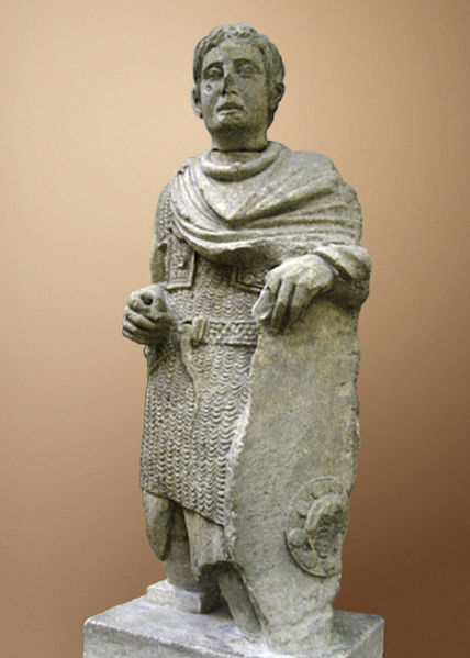 A Gallic warrior dressed in Roman lorica hamata (chainmail) with a cloak over it. Wearing a torc around his neck, he also wields a Celtic-style shield