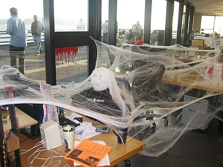 An office desk covered in webs as part of a prank.