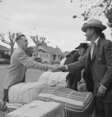 This Dorothea Lange photo (May 8, 1942) was captioned: "Hayward, California. Friends say good-bye as a family of Japanese ancestry await evacuation bus." Hayward, California. Friends say good-bye as family of Japanese ancestry await evacuation bus. Bag . . . - NARA - 537514 (cropped).tif