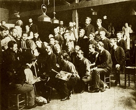 Dans l'Atelier Cormon à Montmartre (10 rue Constance).Fernand Cormon au chevalet, à gauche Henri de Toulouse-Lautrec derrière le chevalet, en haut à droite (flèche) Émile Bernard[4].