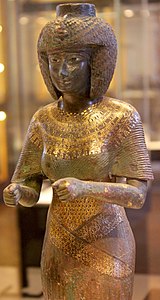 Statue H. 59 cm. Bronze incrusté d'or et d'électrum XXIIe dyn. v. 860. Haute-Égypte Louvre[7]