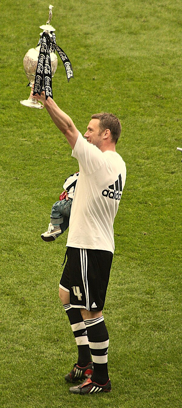 Nolan holding the Championship trophy aloft in 2010