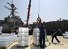 Humanitarian supplies being loaded on McFaul 20 August 2008, at Souda Bay, Crete for delivery to Georgia Loading bottled water on the USS McFaul (DDG 74).jpg