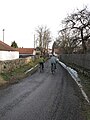 Čeština: Lidé na silnici v Nových Dvorech. Okres Příbram, Česká republika. English: Humans on bicycles in Nové Dvory village, Příbram District, Czech Republic.