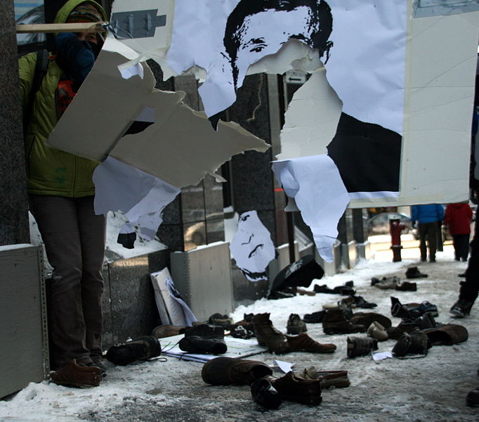 File:Protesters Throwing Shoes at Bush posters in Montreal.jpg