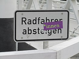 This sign, reading "Radfahrer absteigen" (Cyclists, dismount), has been amended with a gender star to make it gender-neutral. Radfahrer-innen absteigen.JPG