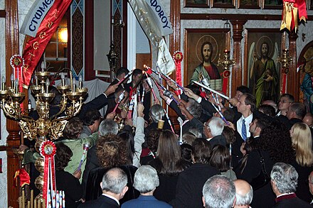 The congregation lighting their candles from the new flame which the priest has retrieved from the altar (St. George Greek Orthodox Church, in Adelaide, Australia).