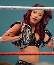 Sasha Banks with the original design of the NXT Women's Championship belt (2013-2017). Sasha Banks NXT Women's Champion.jpg