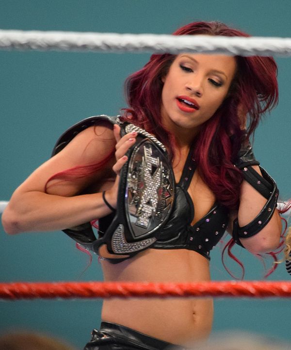 Sasha Banks with the original design of the NXT Women's Championship belt (2013–2017).