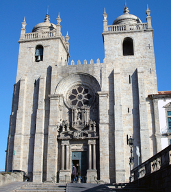 Porto Cathedral, its heavy and imposing facade with thick buttresses was later embellished by a Baroque portal. Se-Catedral-Exterior (4), Se do Porto, 2004.png