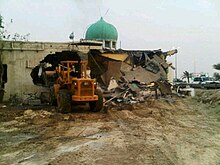 A loader destroying the 400-year-old Amir Mohammed Braighi mosque in A'ali Sheikh Mohammed al-Barbaghi Mosque being demolished.jpg