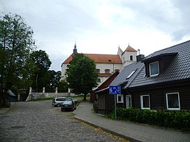 Street in Trakai with a glimpse of the Church of the Visitation.jpg