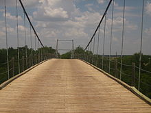 The Regency Suspension Bridge near Goldthwaite which Bob Phillips crosses in the introduction to his Texas Country Reporter television series TCR Suspension Bridge IMG 0786.JPG