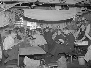 Royal Marines of the Home Fleet typical view of the messdeck after supper on board HMS CUMBERLAND in 1942 The Royal Marines. With the Royal Marines of the Home Fleet, October and November, 1942. A16306.jpg