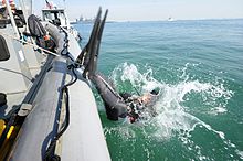 US Navy diver entering the water by backward roll from a RHIB US Navy 101130-N-6070S-120 Navy Diver 1st Class Jason Peters, assigned to Mobile Diving and Salvage Unit (MDSU) 2.jpg