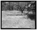 VIEW TO THE NORTHEAST OF COBBLESTONE RETAINING WALL, DRIVEWAY EDGING (AT BOTTOM CENTER), AND NORTHERN CORNER OF THE RANCH HOUSE - Ketch Ranch, Medicine Park, Comanche County, OK HABS OK-66-6.tif