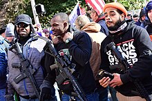 Demonstrators at the 2020 VCDL Lobby Day gun rights rally; one demonstrator can be seen wearing Black Guns Matter apparel. Virginia 2nd Amendment Rally (2020 Jan) - 49416085946.jpg