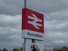 The train station sign at Wymondham, with the double arrow, the corporate identity of National Rail Wymondham Train Station Name Sign.jpg