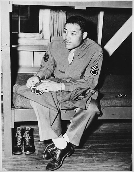 File:"World Heavyweight champ Joe Louis (Barrow) sews on the stripes of a technical sergeant-to which he has been promoted. - NARA - 535937.jpg