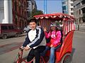 Хальхи велорикша Пекин урамĕнче.