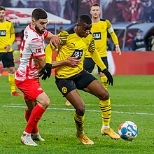 Moukoko with Borussia Dortmund in 2021, defended by Josko Gvardiol 2021-11-06 Fussball, Manner, 1. Bundesliga, RB Leipzig - Borussia Dortmund 1DX 1735 by Stepro.jpg