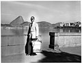 A diplomatic courier stands by a sea wall with his pouch, circa 1950s. (44656057655).jpg