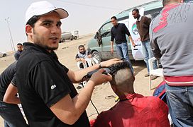 A politically motivated buzz cut in progress during the Libyan Crisis