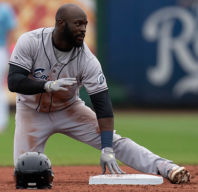 Having lost his batting helmet, Anthony Alford requests time after reaching base safely during a 2022 Minor League Baseball game.