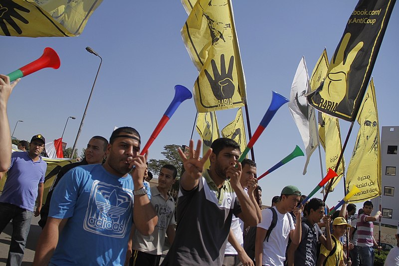 File:Anti-coup protesters with R4bia sign in Nasr City-Cairo 11-Oct-2013.jpg