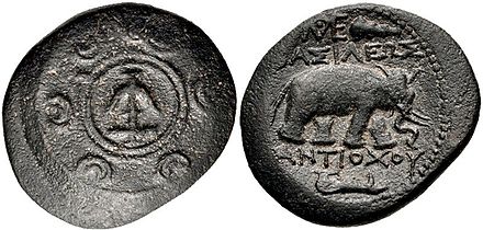 Antiochos I coin. Antioch mint. Macedonian shield with Seleucid anchor in central boss. Elephant walking right.
