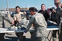 A shooting victim being transported to a waiting ambulance Army mil-55427-2009-11-07-171121.jpg