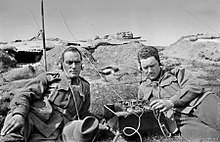 A pair of Australian signallers, each wearing a headphone set, listen in on an early Marconi Mk III crystal shortwave tuner set. The men are probably conducting a training exercise at the signalling school at Broadmeadows, Victoria Australian signallers 1916.jpg