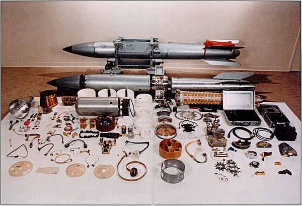 A B61 nuclear bomb in various stages of assembly; the nuclear warhead is the bullet-shaped silver canister in the middle-left of the photograph.