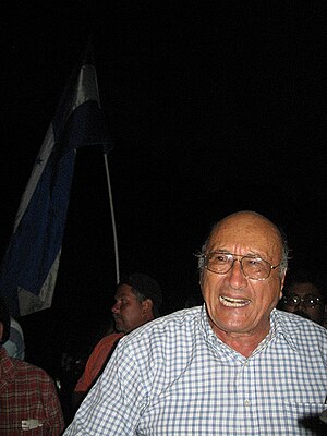 Carlos H. Reyes in July 2009, with Honduran flag in background Carlos H Reyes.jpg