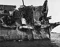 View of the USS Independence (CVL-22)'s port quarter, showing severe blast damage caused by the "Gilda" nuclear bomb air burst at Bikini on 1 July 1946. Photographed at Bikini anchorage on 23 July 1946.