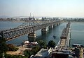 The current Sino-Korean Friendship Bridge next to the ruins of the old bridge