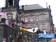 Anti-fascist protesters in 2005; the blue banner reads, "All good things come from above". Dresden 130205 Gegenproteste.jpg