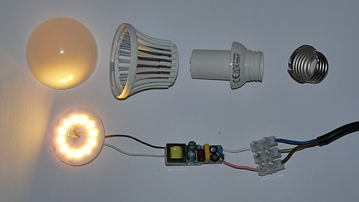 Disassembled LED-light bulb with switched-mode power supply circuit board and Edison screw