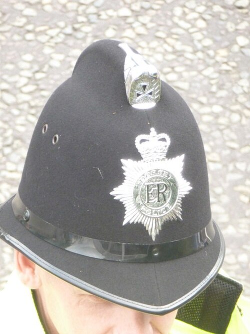 A Dorset Police officer in Ensbury Park, Bournemouth. Since 1863, the custodian helmet has been worn by male police constables and sergeants while on 