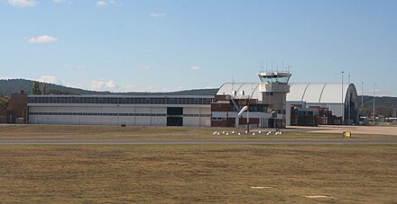 The hangars and air traffic control tower of Defence Establishment Fairbairn, viewed from the main runway.