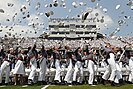 Cadets from the United States Military Academy at West Point toss their hats