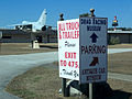 Signs guiding visitors in museum parking lot.