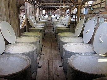 The olive vat room at Graber Olive House in Ontario, California. In 1894, two years after planting olive trees in Ontario, C. C. Graber began selling vat cured olives from the pictured vat room in vats similar to the ones pictured. Graber Olive House is the oldest operating olive packer in the United States.