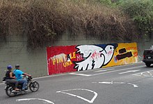A wall painting that previously criticized barricades was changed to criticize the "dictatorship". Guarimba Wall Painting 2.JPG