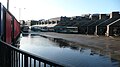 English: Guildford Friary bus station, Guildford, Surrey, seen after heavy rainful. This part of the bus station often floods after heavy rain as seen here. This is by no means a particually bad flood, sometime it strecthed right across the the backs of the buses on stand, leaving buses with no option but to drive through the flood.