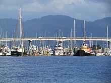 View of southernmost span of the "Samoa Bridge." Woodley Island Marina (on Humboldt Bay), Eureka, in the foreground with easterly views of Fickle Hill (Coast Ranges) in the background. Highway 255 behind Woodley Island Marina.jpg
